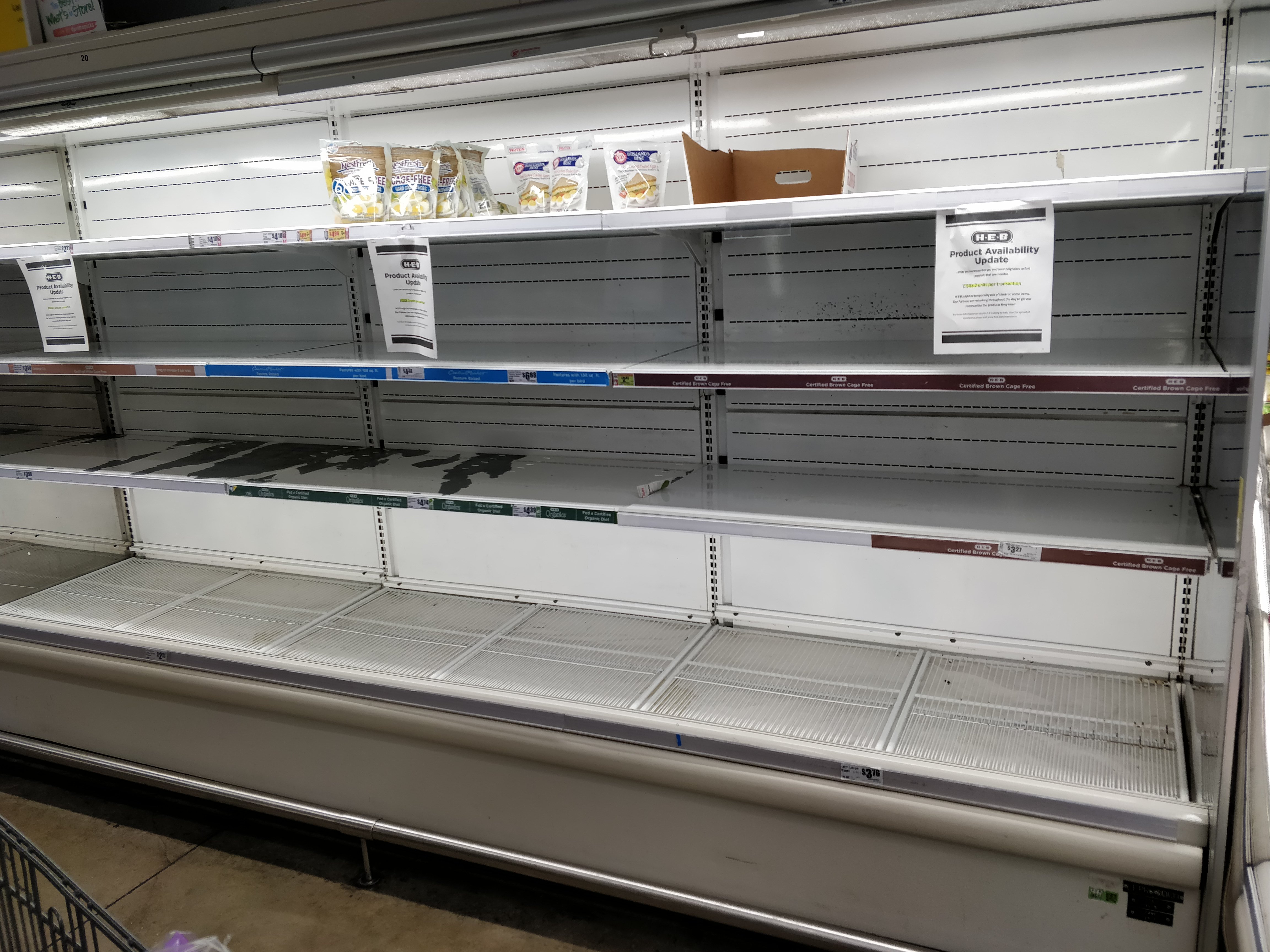 grocery store with empty cooler shelves March 2020